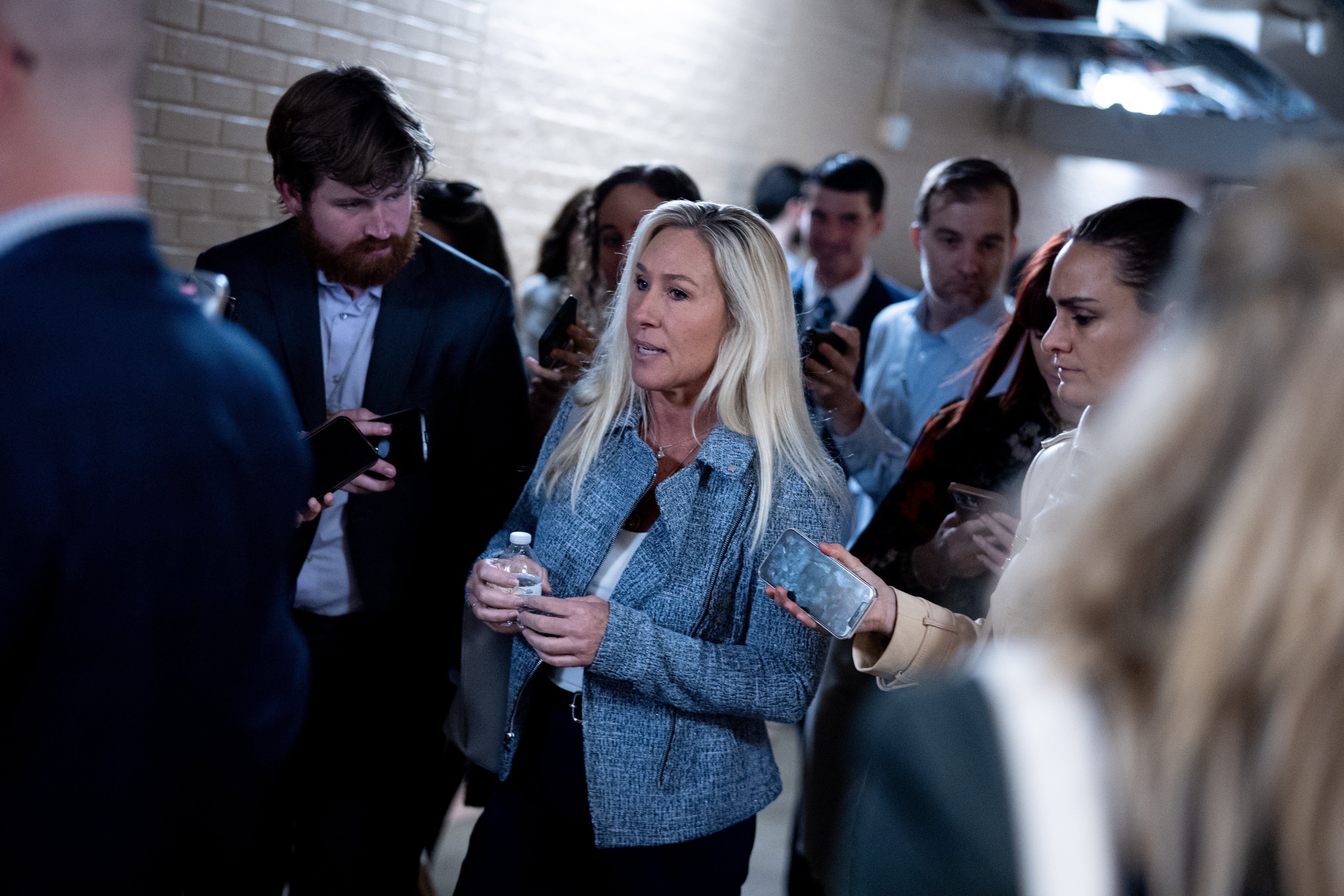 Rep. Marjorie Taylor Greene speaks to reporters as she leaves a House Republican Caucus meeting on Capitol Hill last month in Washington, D.C. She has suggested that the government can control the weather