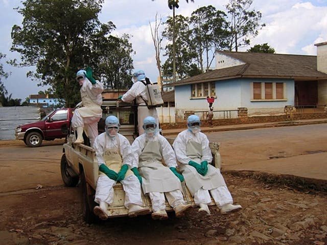 <p>Health workers in protective suits respond to a previous Marburg virus outbreak in Angola in April 2005</p>