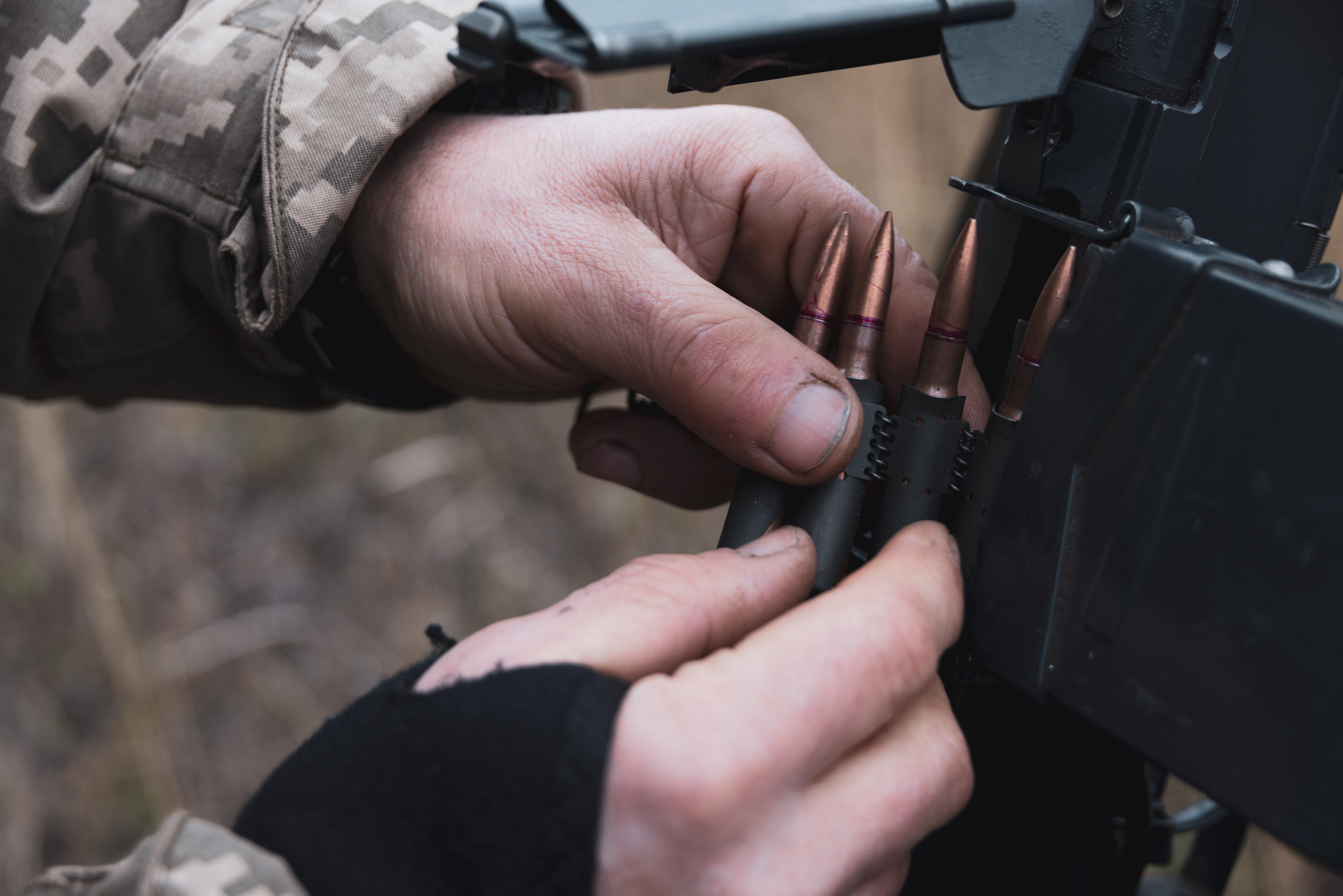 The commander of a mobile firing group of the 118th Motorized Rifle Brigade prepares a machine gun on a tripod to fire at Russian drones in Zaporizhzhia