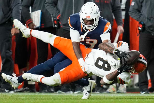 Cleveland Browns wide receiver Elijah Moore is tackled by Denver Broncos cornerback Ja’Quan McMillian (AP Jack Dempsey)