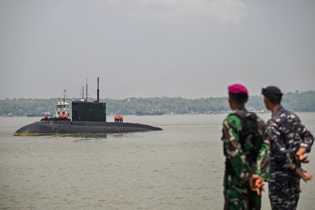 <p>Crew members stand on the Russian Navy’s UFA submarine as it prepares to dock at the North Jamrud pier of Tanjung Perak port for a 5-day joint military exercise between Indonesia and Russia</p>