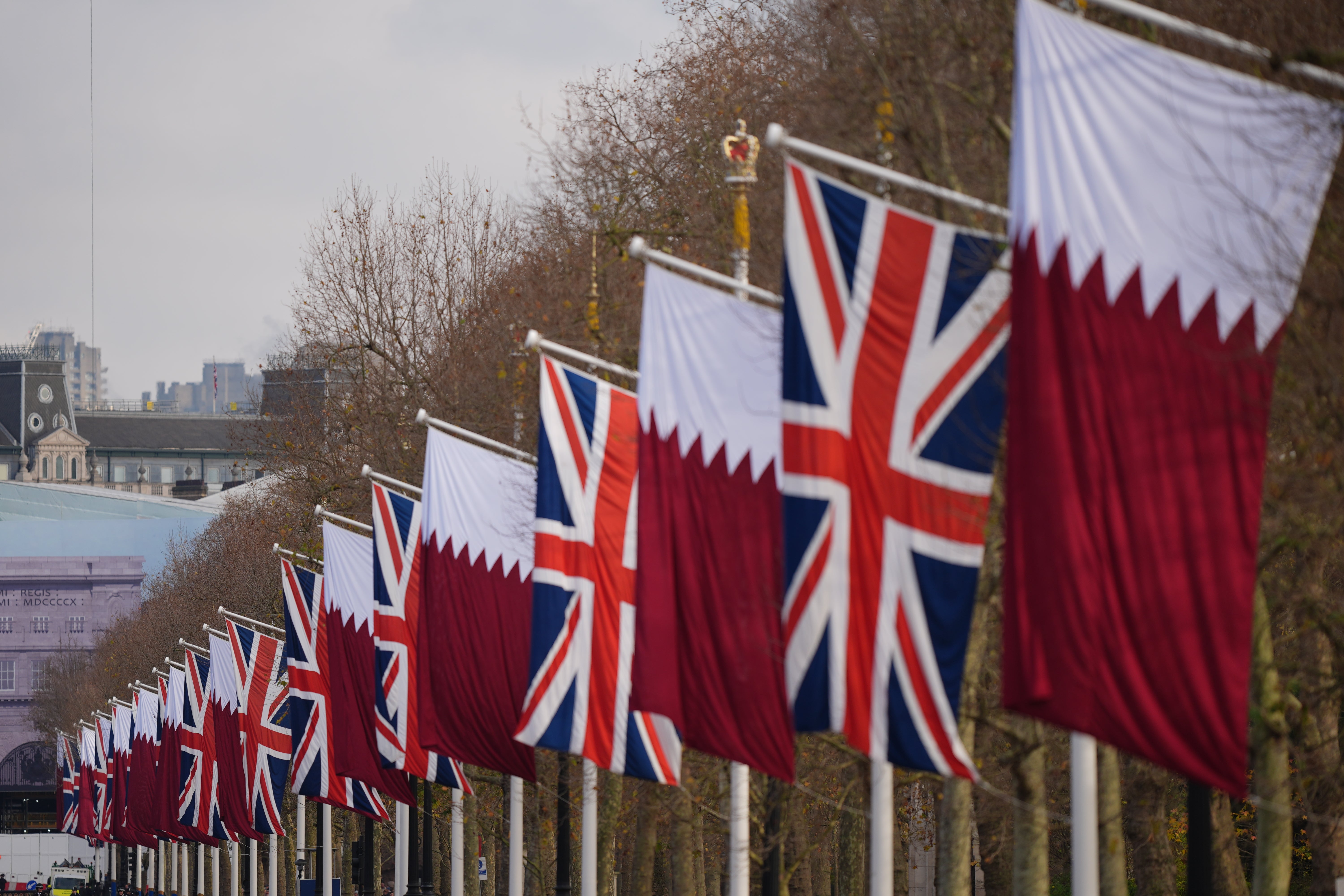 Union flags and flags of Qatar line The Mall in London on Tuesday