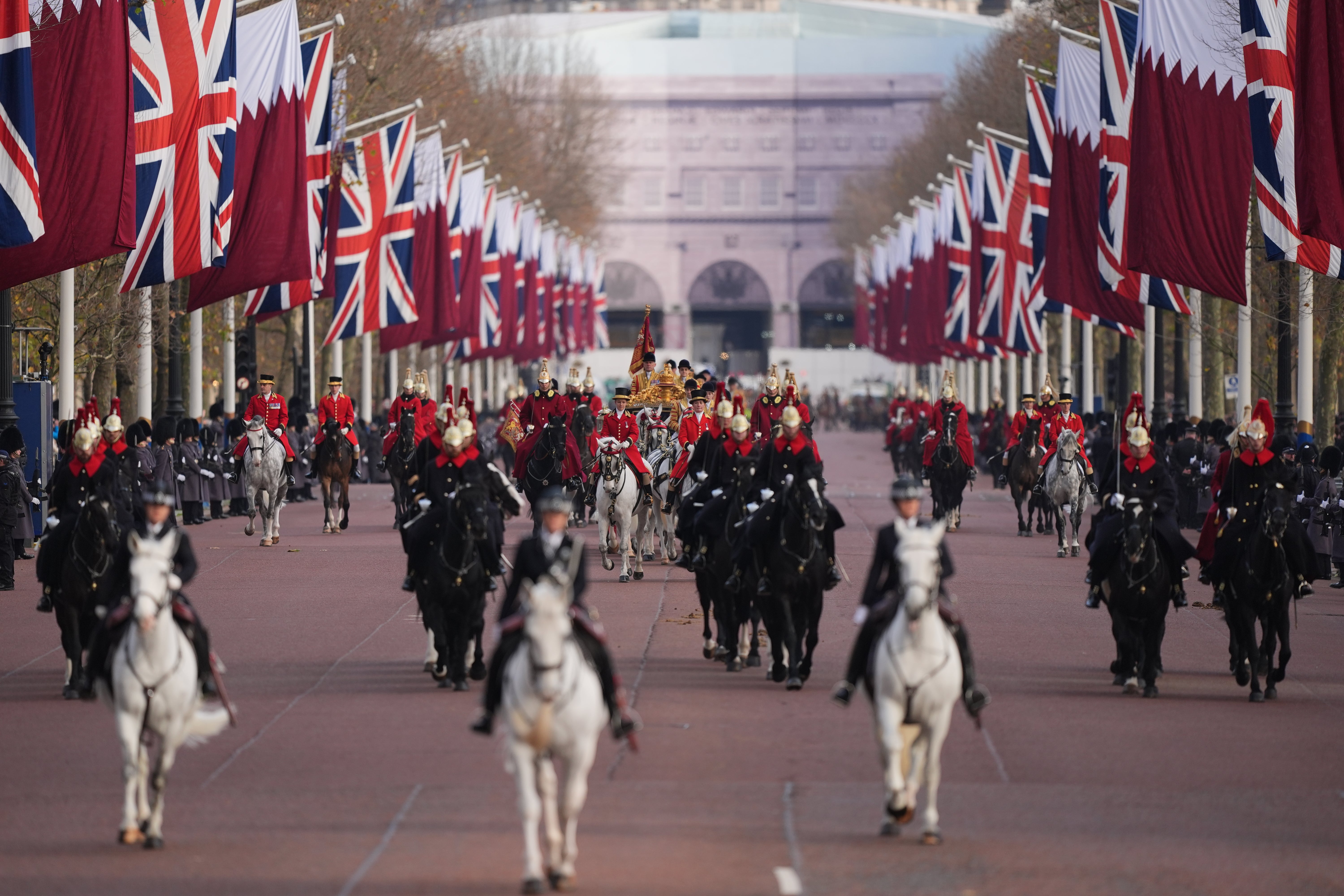 The trio are seen along The Mall to Buckingham Palace in London, following a ceremonial welcome at Horse Guards Parade for their state visit to the UK