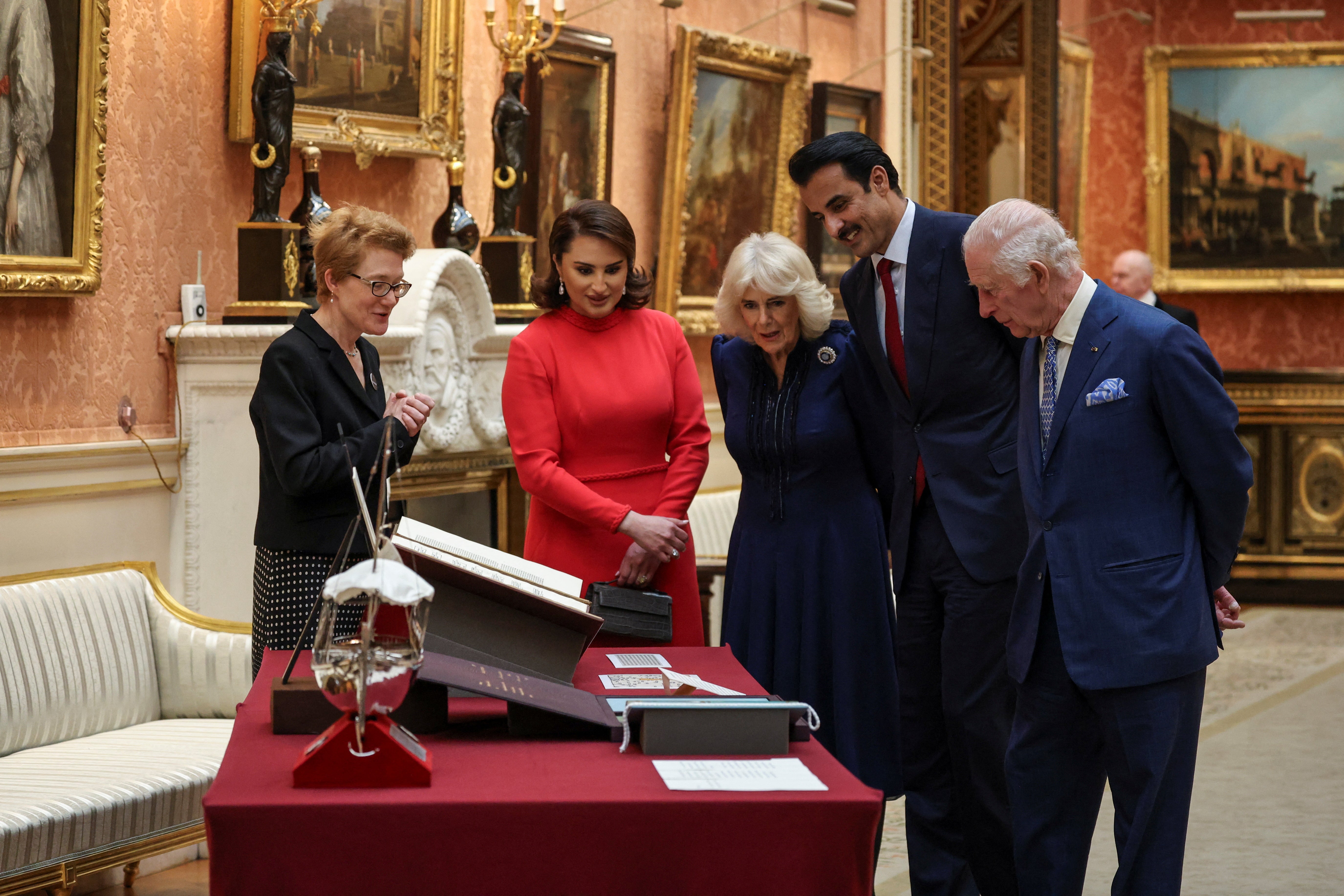 The royal party view a display of Qatari items from the Royal Collection at Buckingham Palace in London