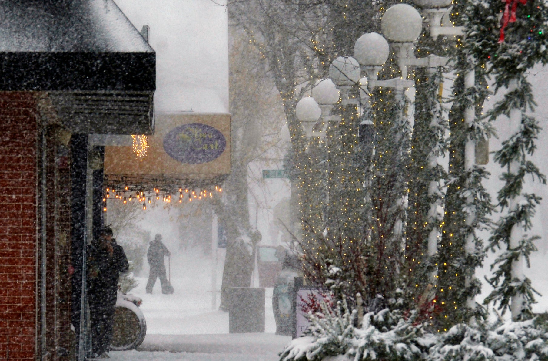 Shoppers walk through blowing and drifting snow on Monday in St. Joseph, Michigan. Michigan saw several feet of lake-effect snow over the course of the last few days