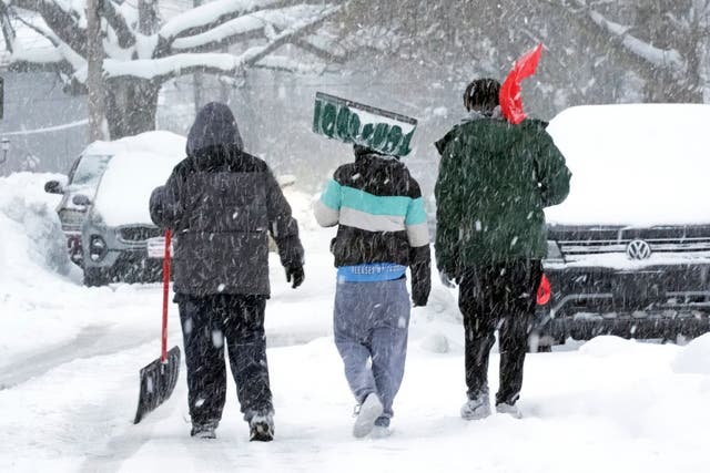 <p>Boys walk down a snow-covered side street in Erie, Pennsylvia, on Monday. More snow is forecast this week across the U.S. </p>