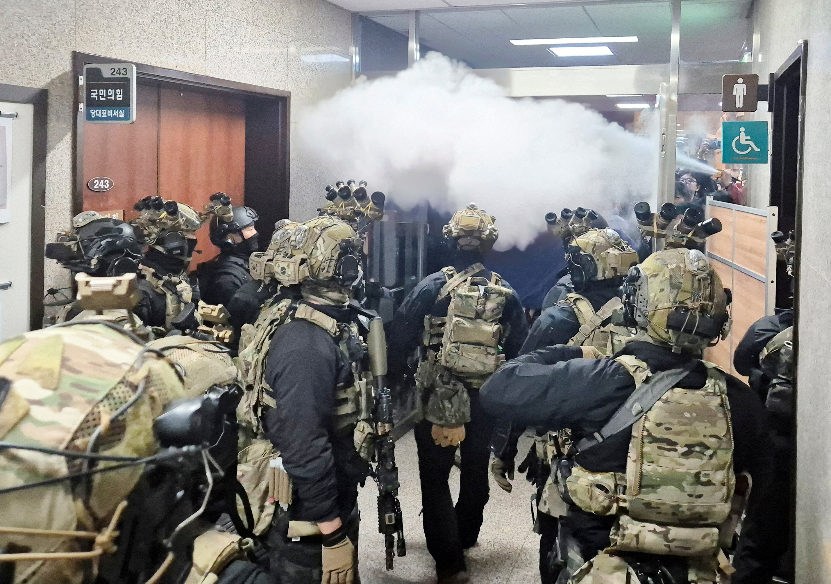 Soldiers advance to the main building of the National Assembly after South Korean president Yoon Suk Yeol declared martial law in Seoul