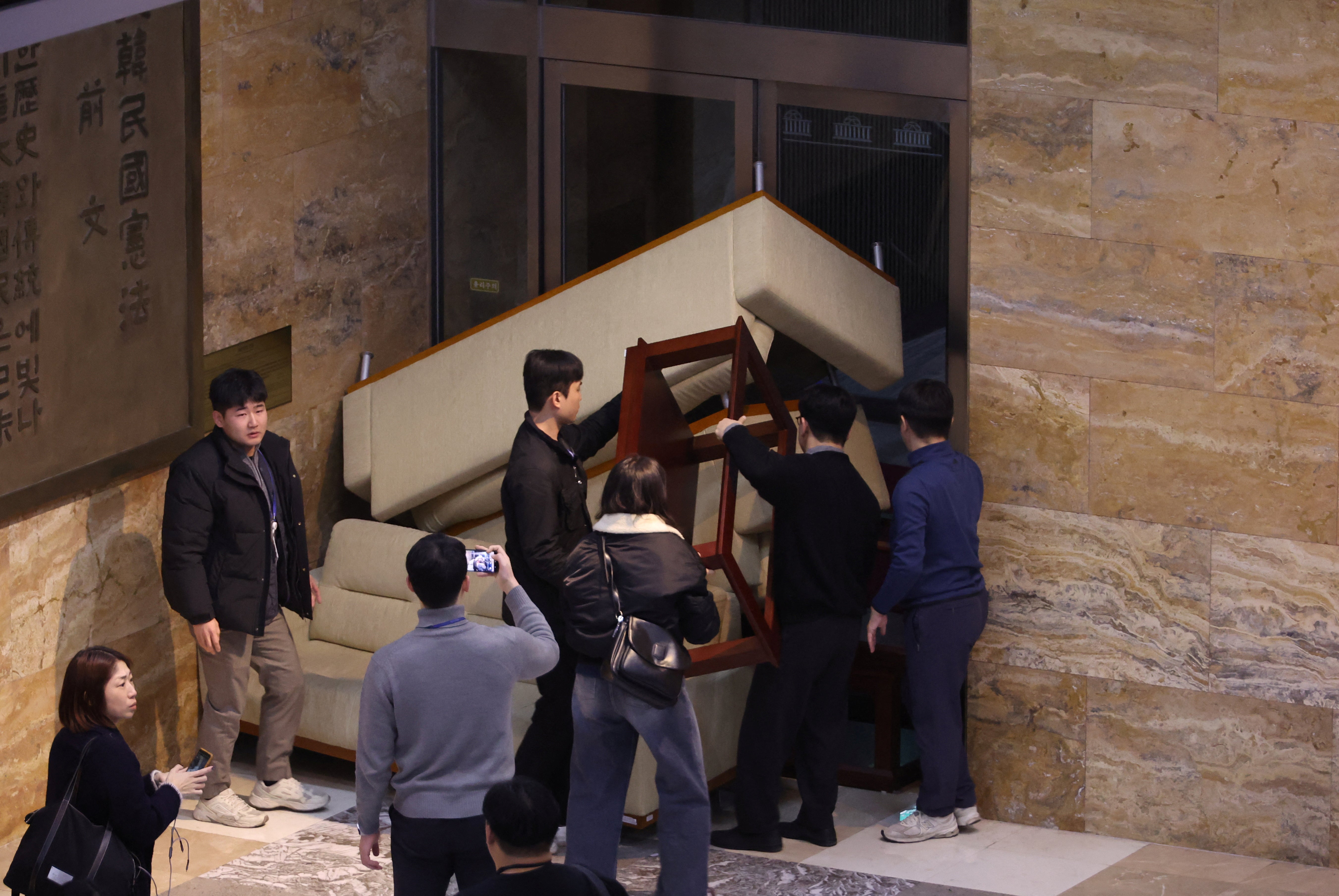 South Korea's main opposition Democratic Party's staff set up a barricade to block soldiers at the National Assembly