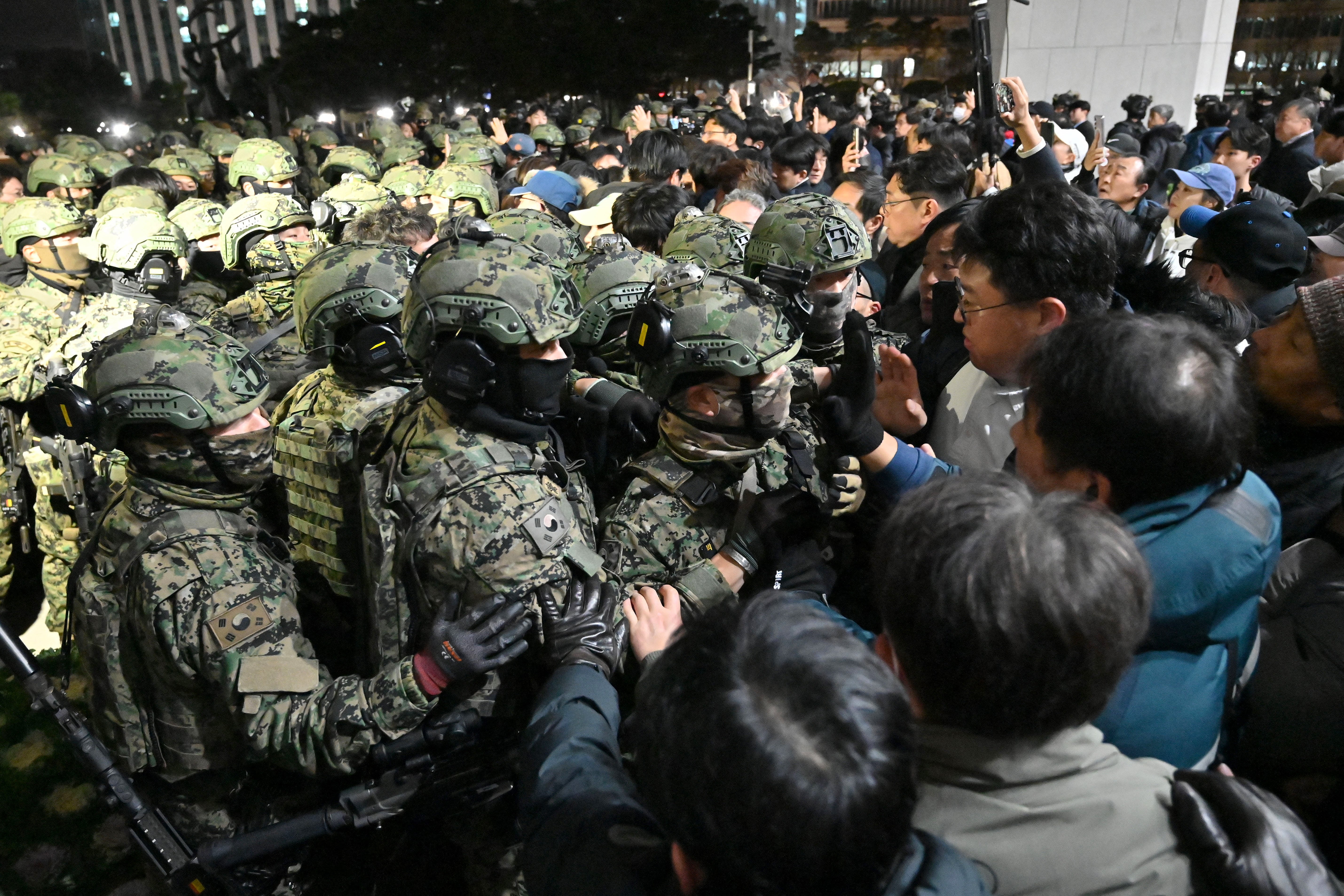 <p>South Korean forces clash with crowds outside parliament after martial law declared </p>