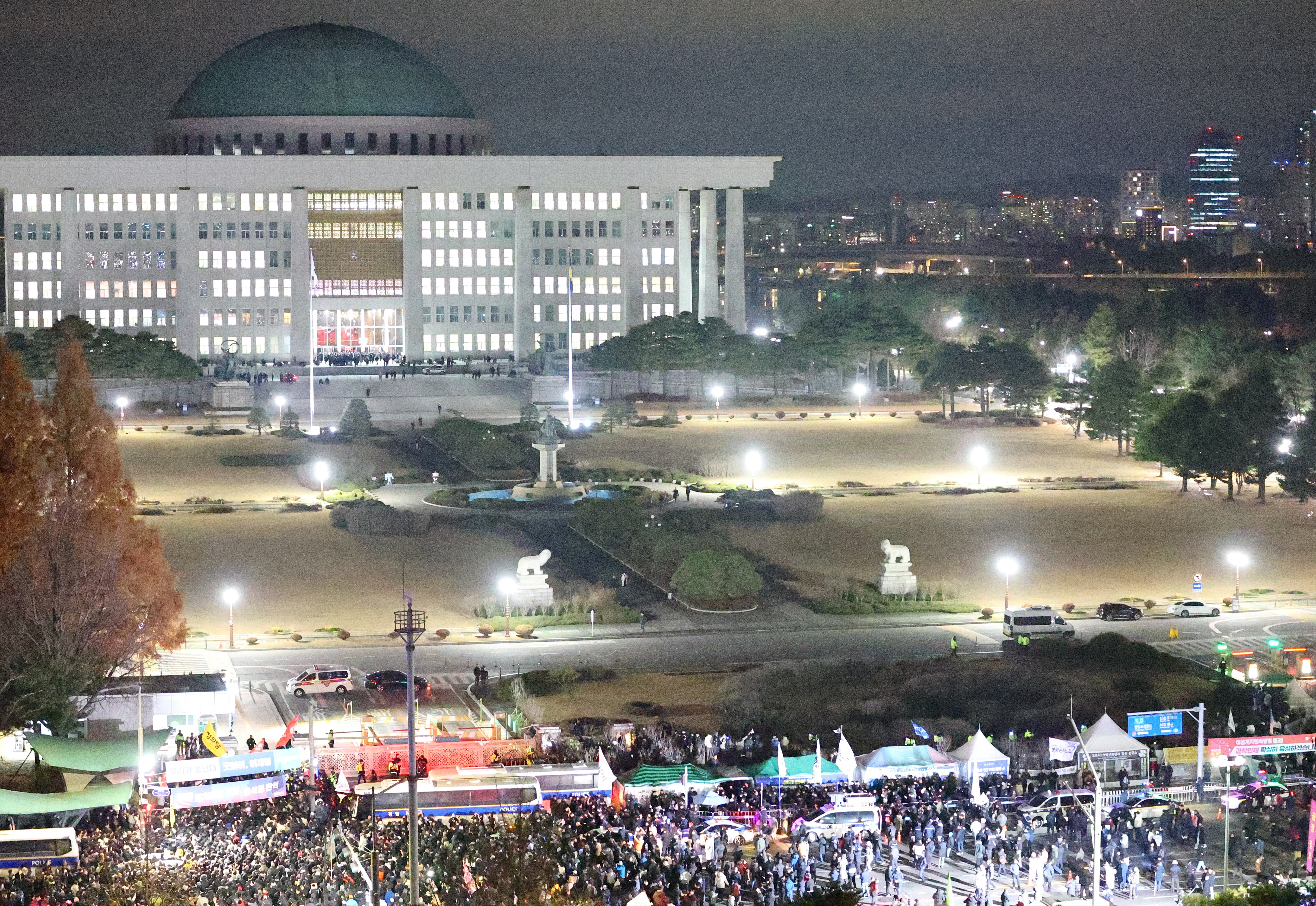 Police officers block protesters outside the National Assembly after South Korean President Yoon Suk Yeol declared martial law in Seoul, South Korea