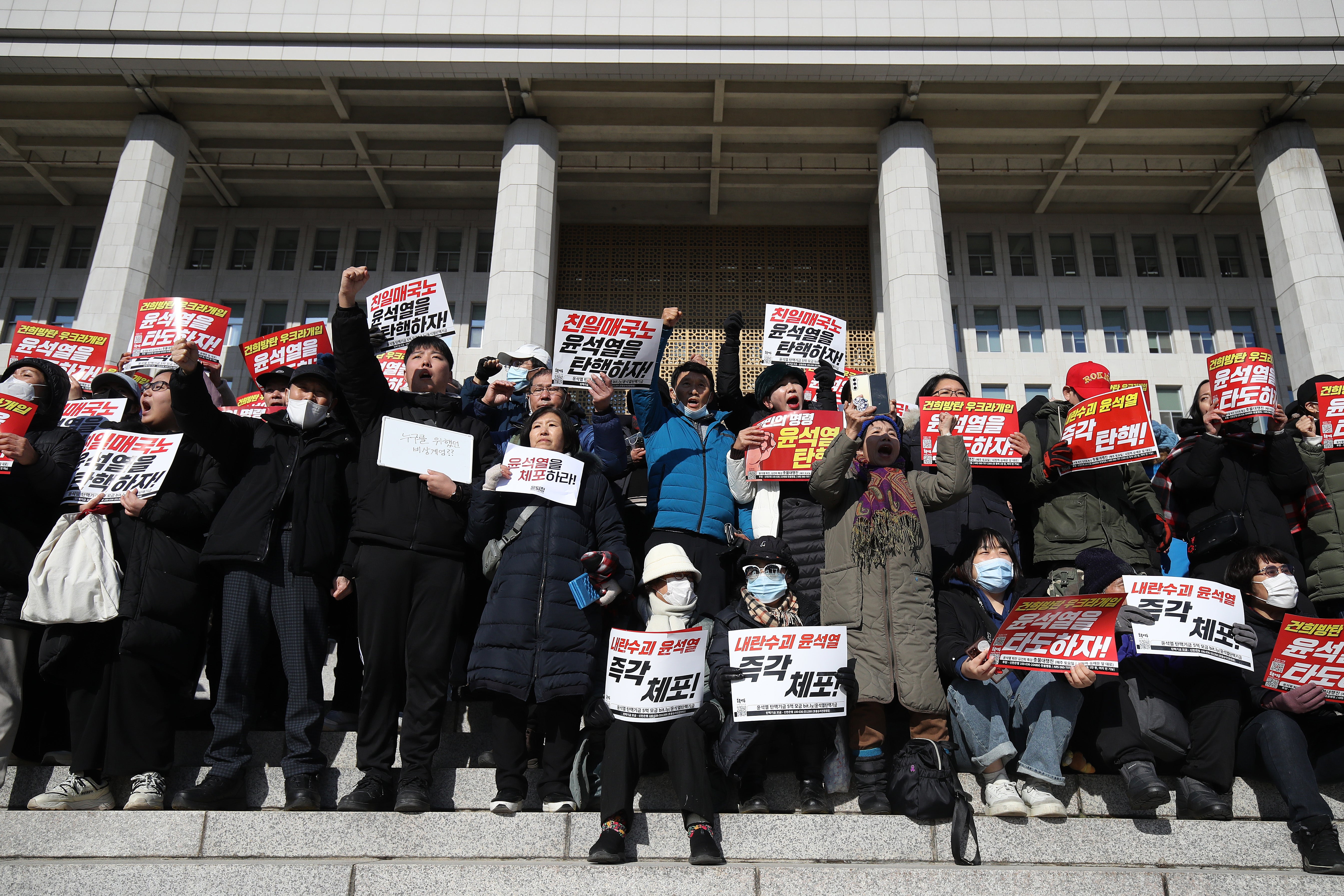 Protesters demonstrate against the country’s president at the National Assembly on 4 December 2024 in Seoul