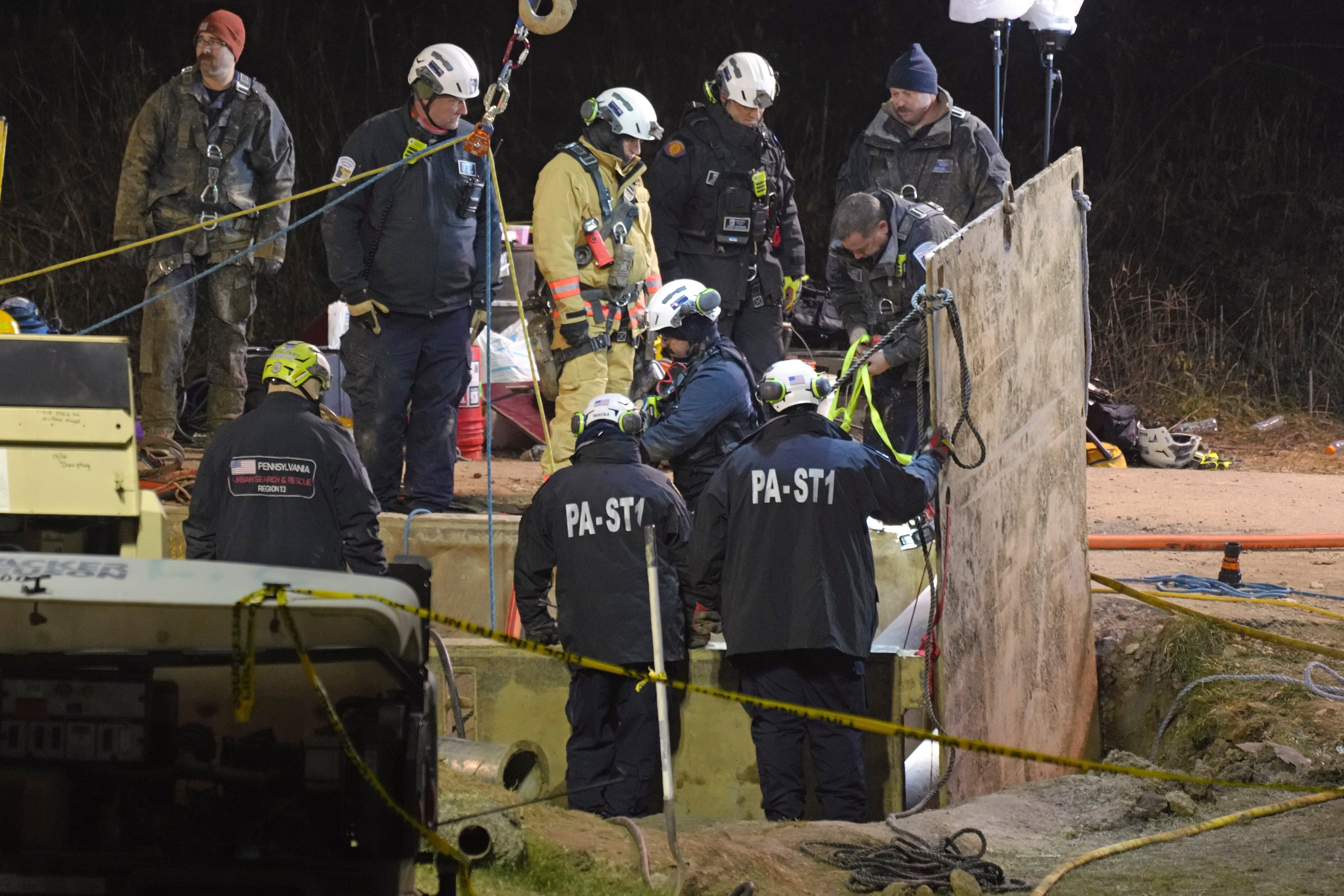 Rescue workers search through the night in a sinkhole for Elizabeth Pollard