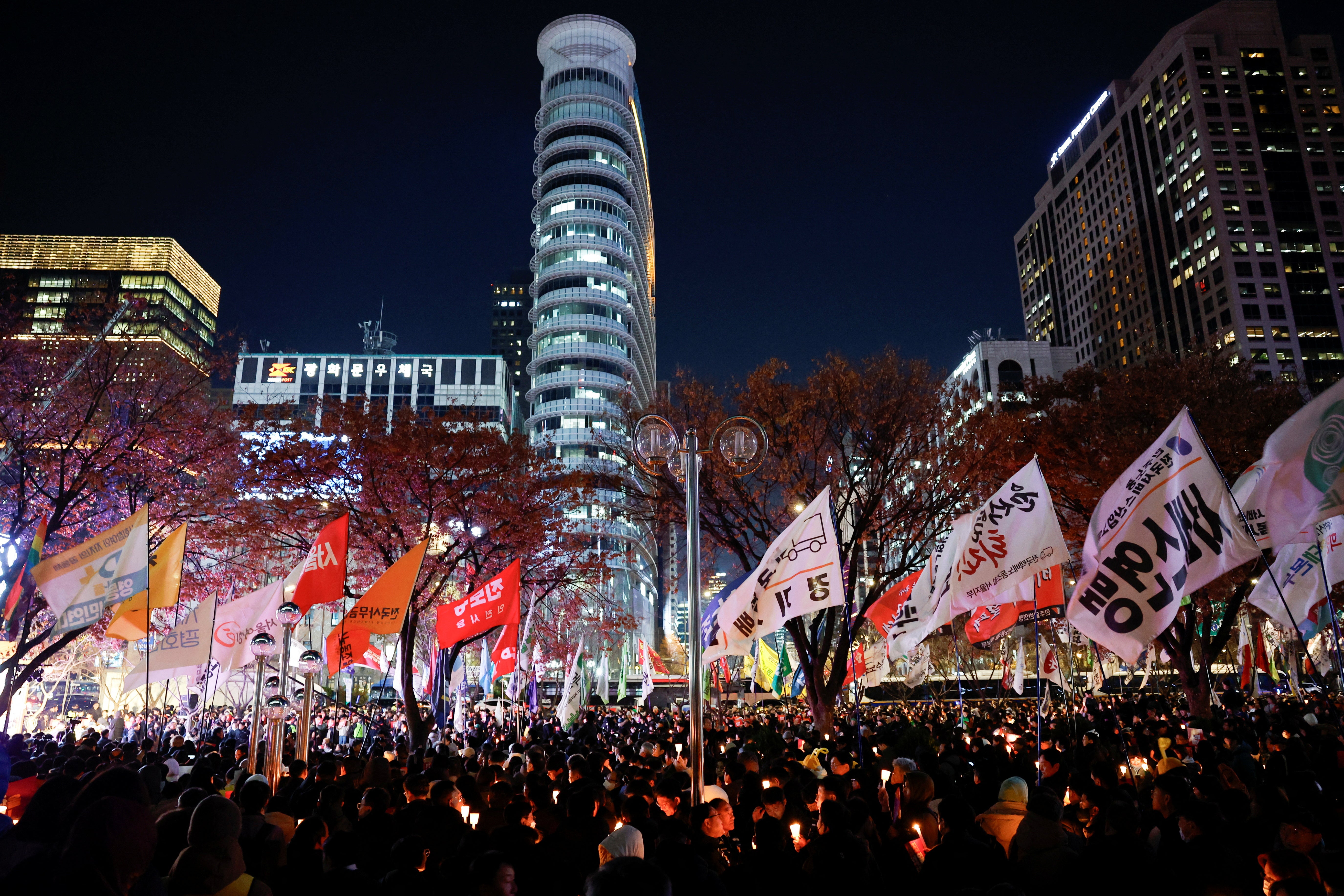 People attend a demonstration condemning South Korean President Yoon Suk Yeol’s surprise declaration of martial law