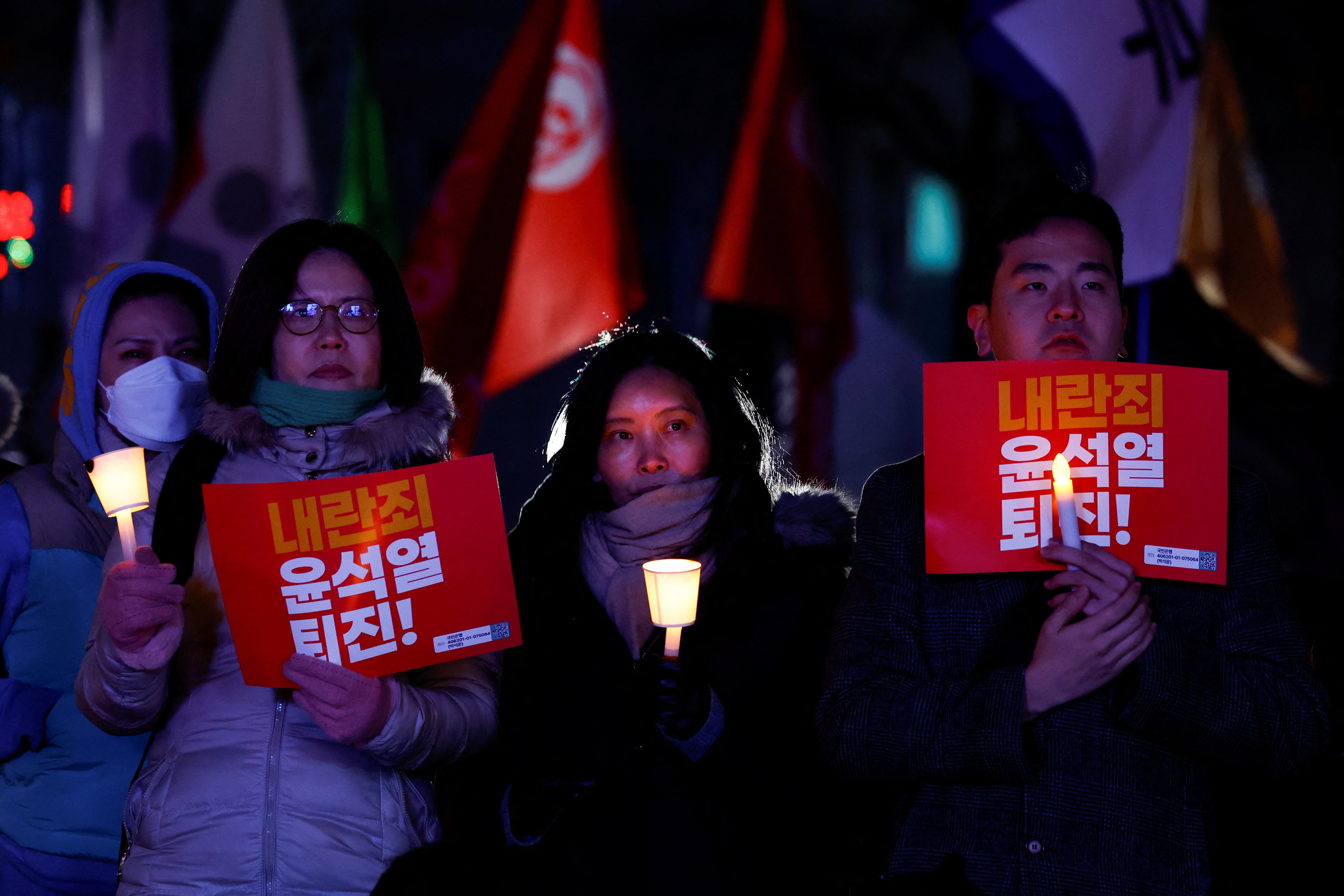 People in Seoul attend a candlelight vigil condemning the actions of the president