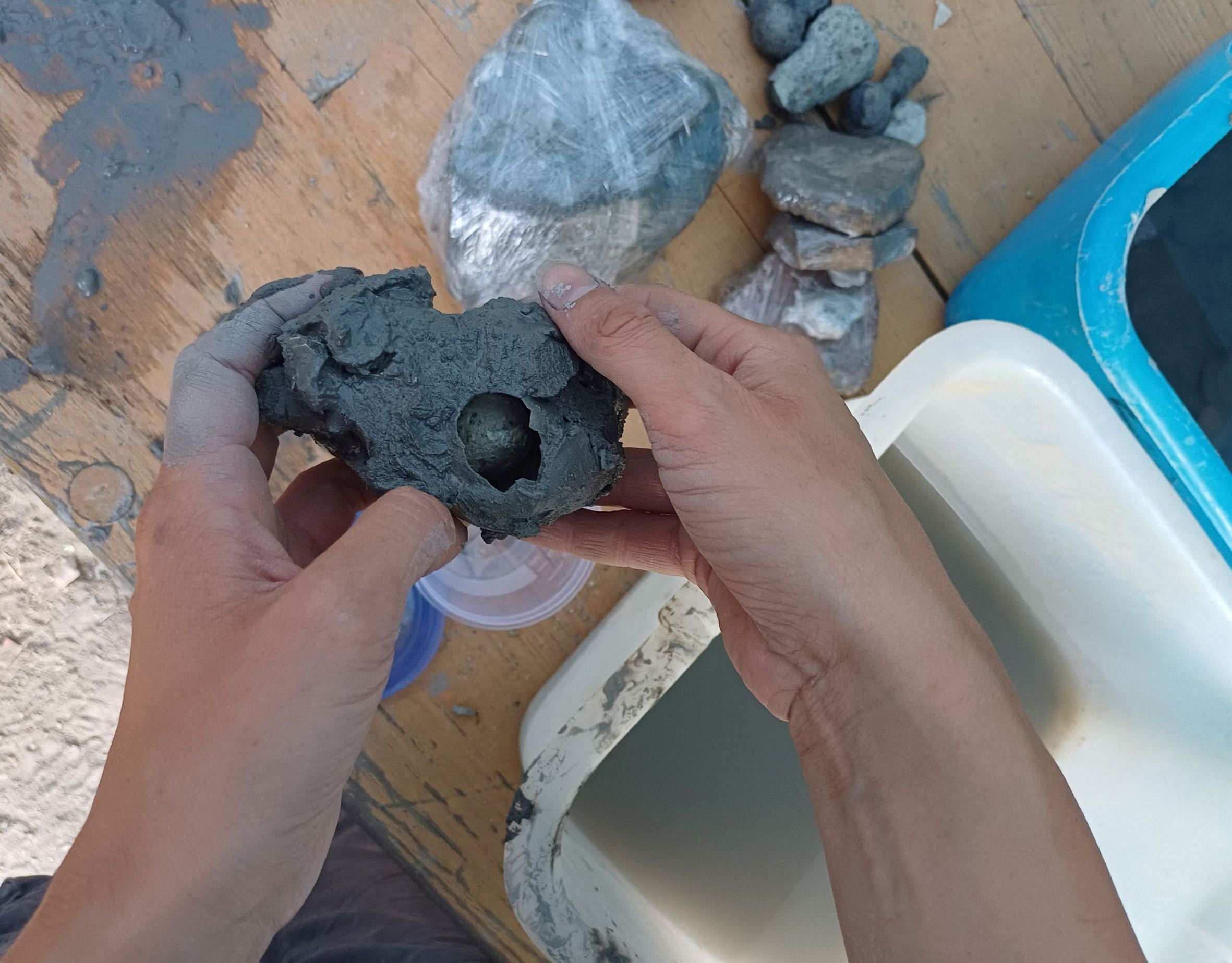 An egg is shown during restoration after it was discovered and pulled out from the muddy ruins of an ancient spa in San Casciano dei Bagni