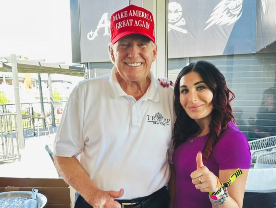 Donald Trump and Laura Loomer pose at an LIV golf event in August 2023