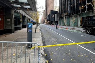 New York police officers walk outside the hotel in midtown Manhattan where Brian Thompson, the chief executive of UnitedHealthcare, was shot dead (Joe Frederick/AP)