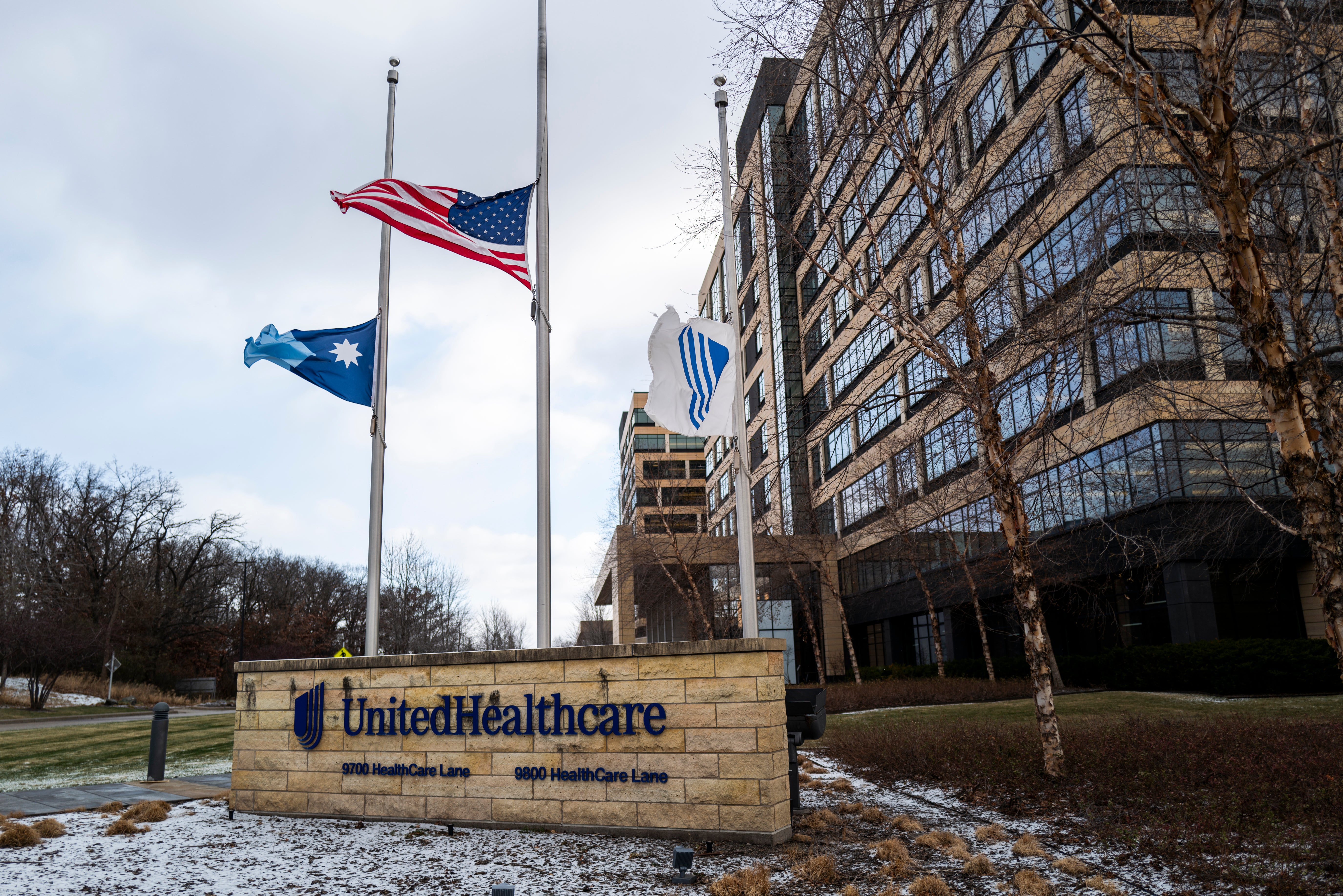 Flags fly at half mast outside the UnitedHealthcare corporate headquarters in Minnetonka, Minnesota Wednesday. Minnesota Governor Tim Walz, New York Governor Kathy Hochul and other leaders have passed on their condolences to Thompson’s family