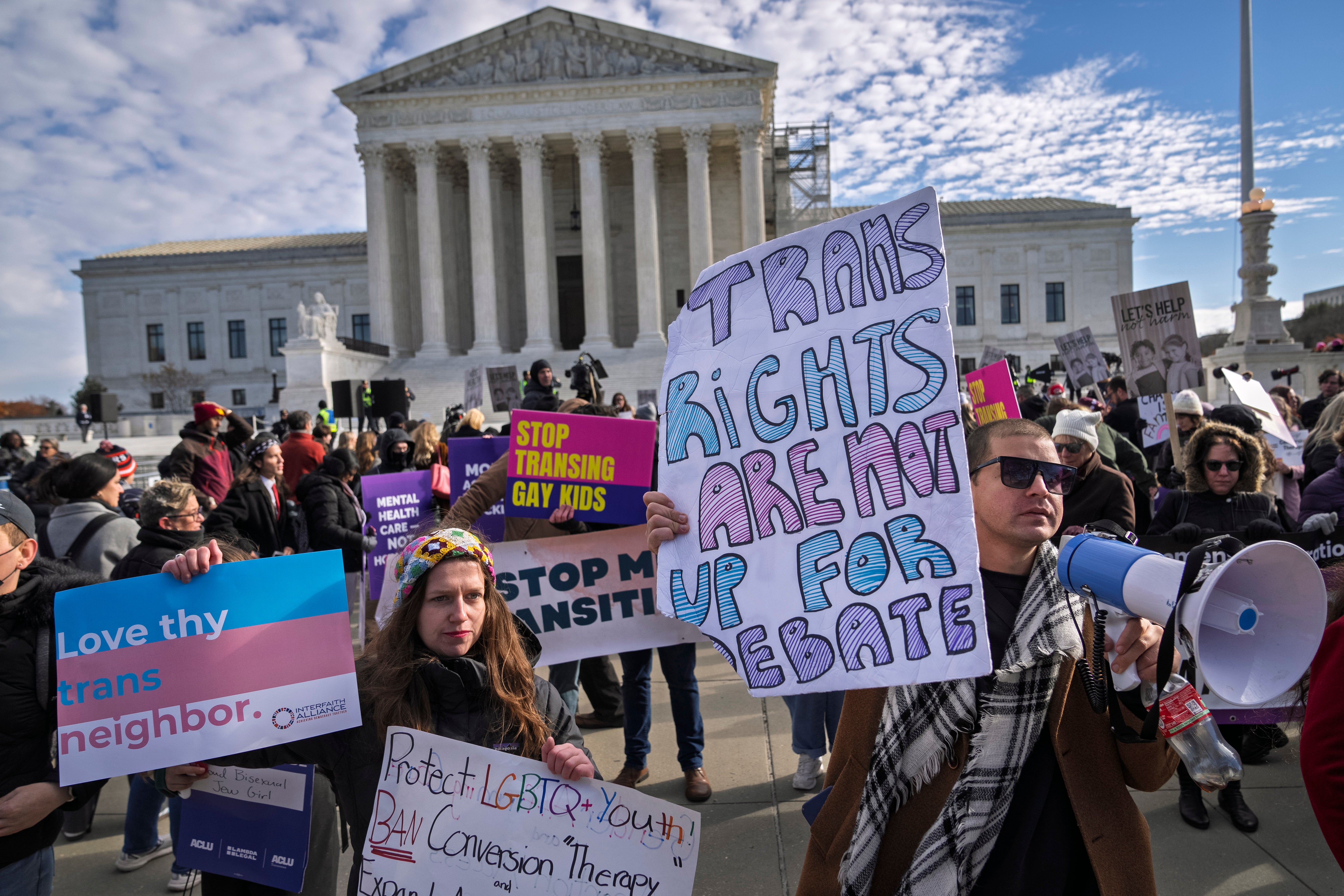 <p>Advocates for transgender rights rallied outside the Surpeme Court on December 4 as justices heard arguments in a landmark case on gender-affirming healthcare </p>