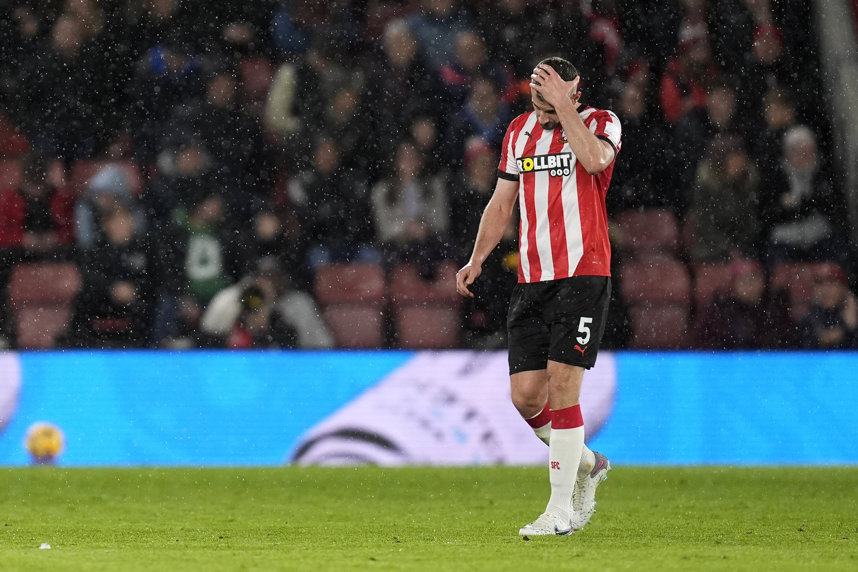 Jack Stephens leaves the pitch after being shown a red card (Andrew Matthews/PA)