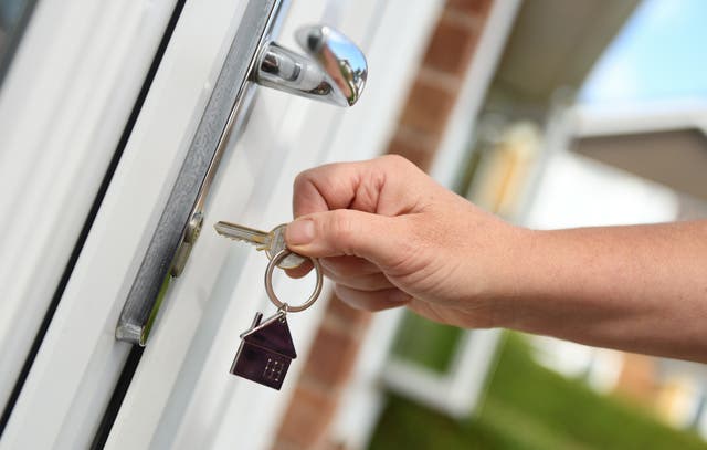 <p>A man opens the door to a house with a key. New research from Oxford University has found owning a home in early adult life added approximately four months to the lives of male Americans born in the early twentieth century</p>