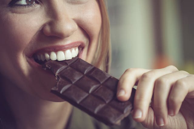 <p>A woman eats dark chocolate. More than 38 million Americans live with diabetes. Eating dark chocolate is linked to a lower risk of type 2 diabetes, researchers said</p>