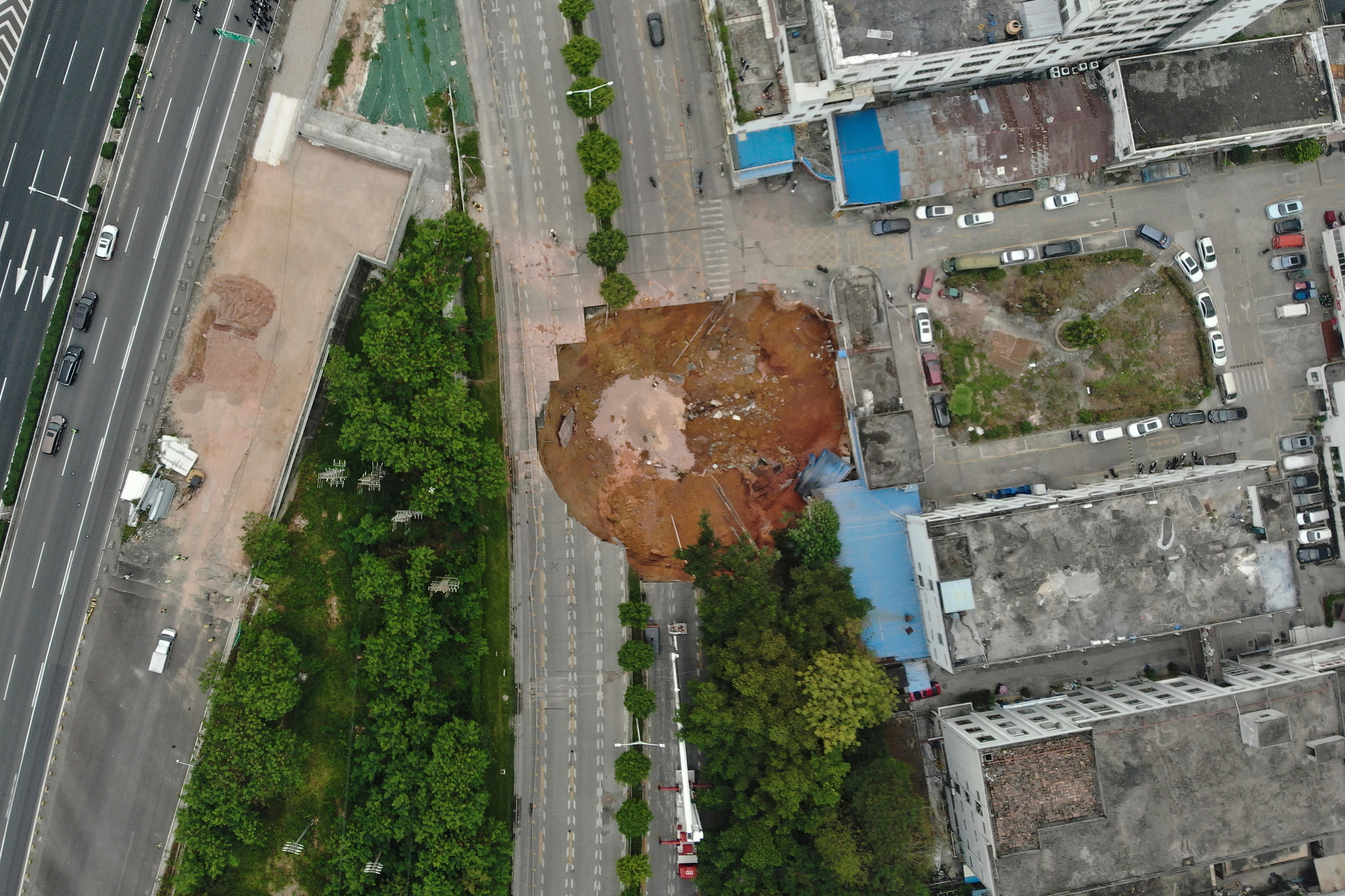 In this photo released by Xinhua News Agency, an aerial view shows the collapsed ground at a construction site on a section of the Shenzhen-Jiangmen Railway in Shenzhen, south China’s Guangdong Province Thursday, 5 December 2024