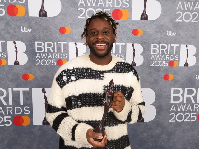 <p>Singer-songwriter Myles Smith with his Brit Award</p>