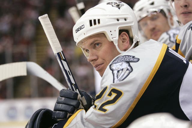 <p>Greg Johnson, of the Nashville Predators, looks on from the bench during the game against the Detroit Red Wings in March 2006. Johnson was posthumously diagnosed with the neurodegenerative disease known as CTE. Now, a new study has found that odds of developing the disease increased by 34 percent with each year men played </p>