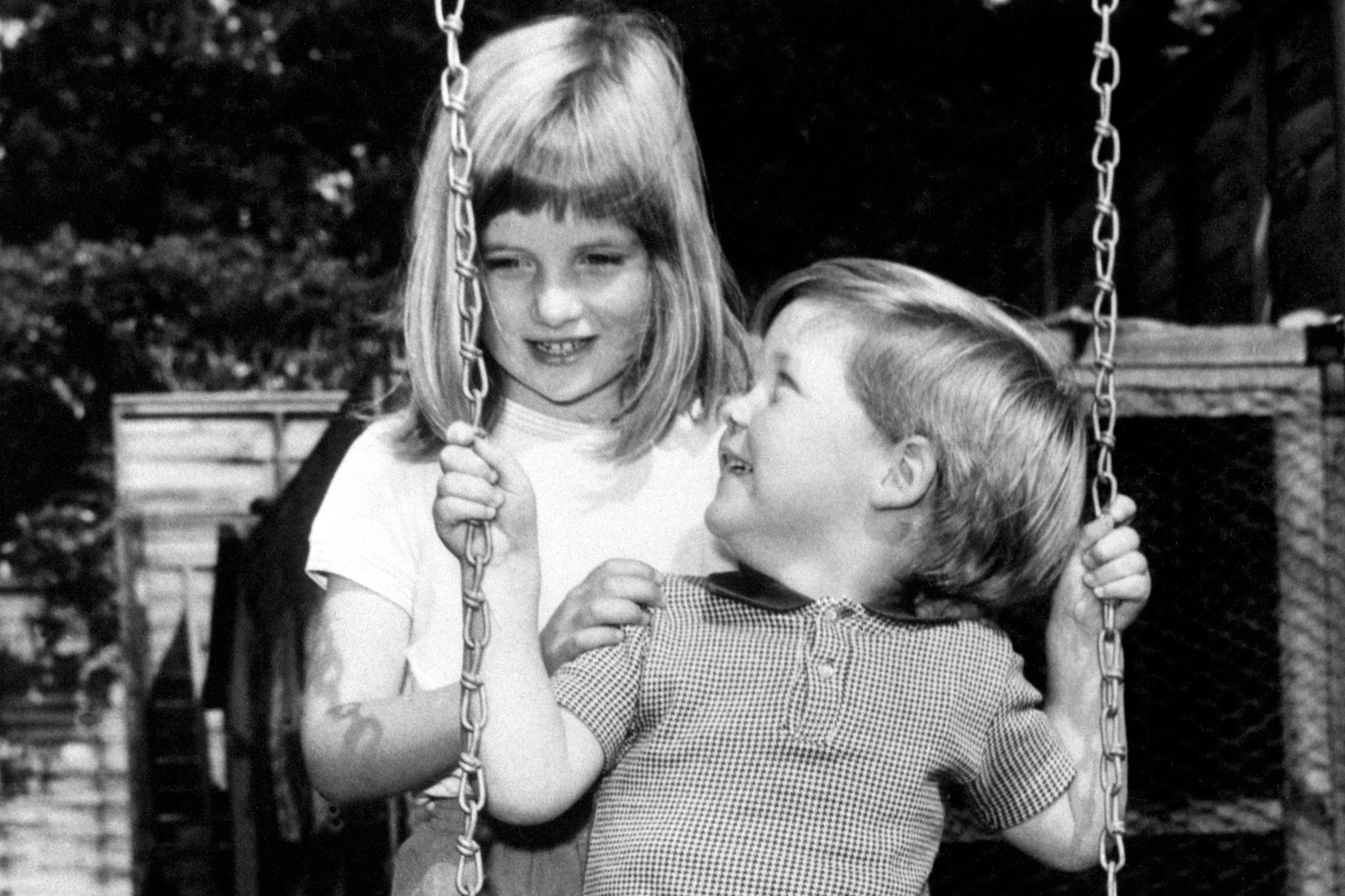 A young Spencer is pushed on a swing by his sister Diana, back in 1967