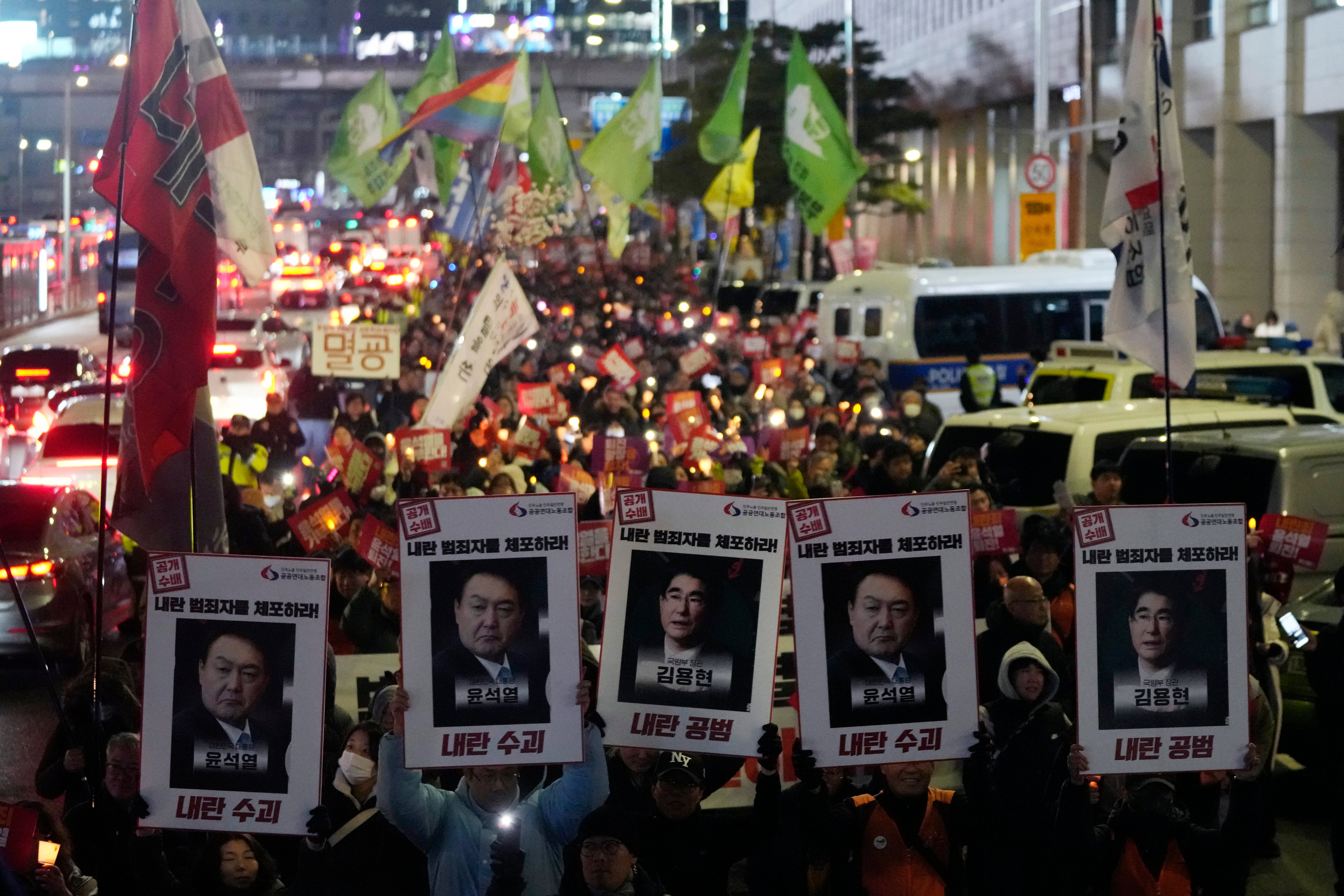 Protesters march to the presidential office after a candlelight vigil against president Yoon Suk Yeol in Seoul on 5 December 2024