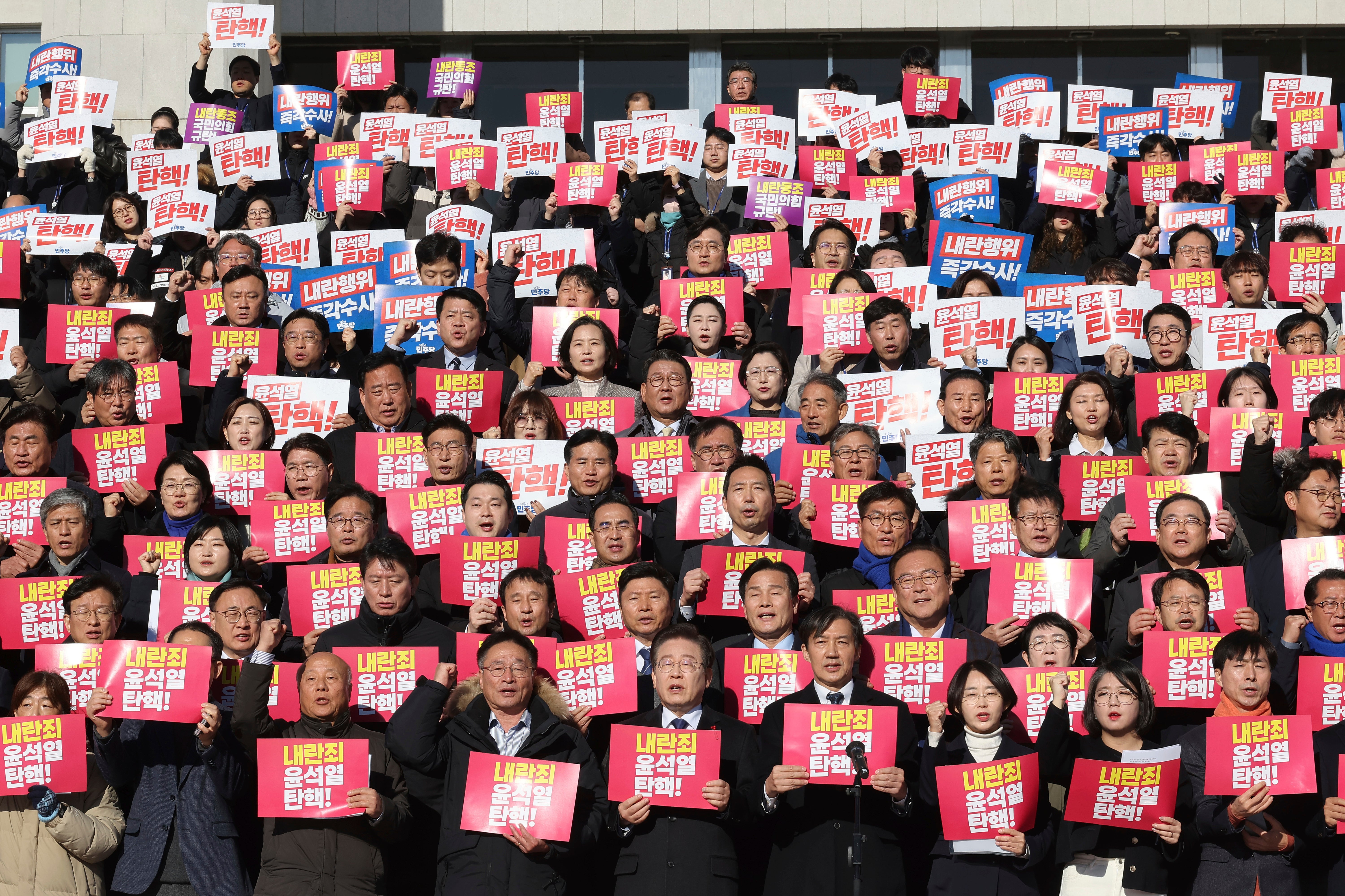 Democratic Party leader Lee Jae Myung, bottom centre, shouts slogans during a joint press conference with members of civil society in Seoul