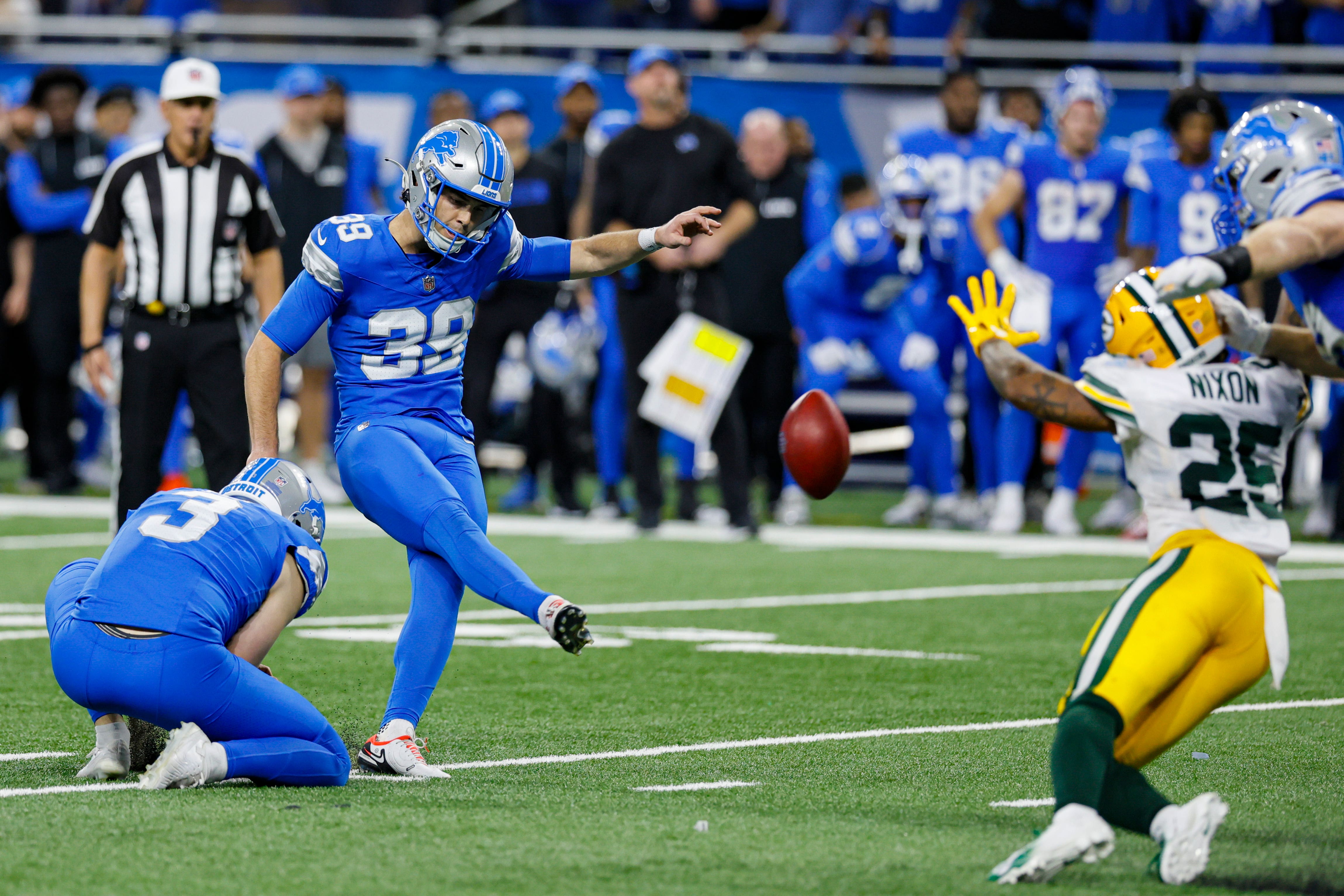 Detroit Lions place kicker Jake Bates (39) kicks a game-winning field goal from the hold of Jack Fox (3) (Duane Burleson/AP)