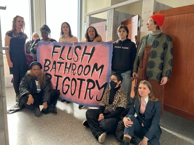 <p>Chelsea Manning, bottom-right, sits with other protesters in a congressional bathroom on Thursday December 5, 2024</p>