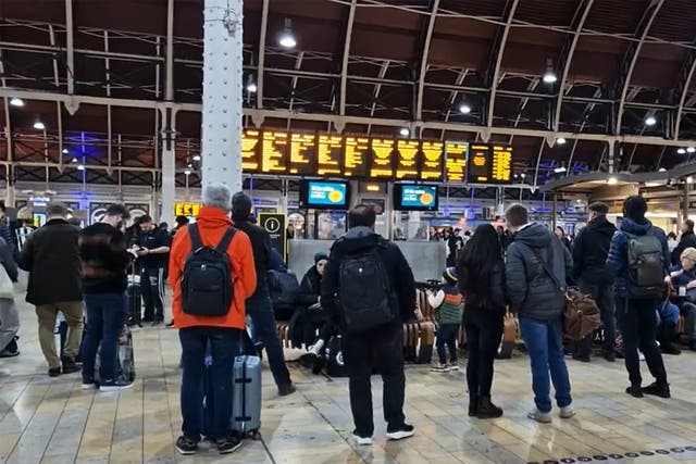 <p>Travellers at Paddington railway station in London</p>