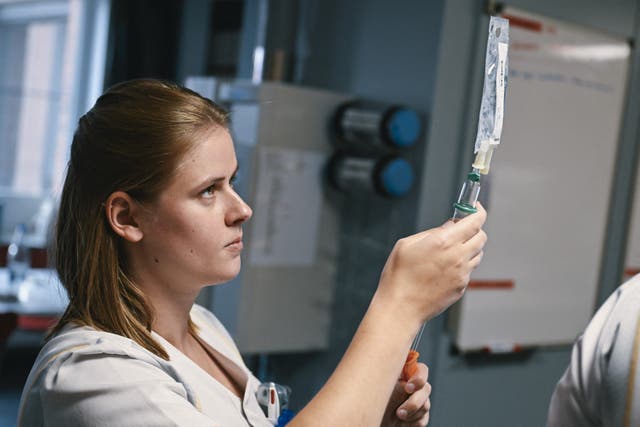 <p>Representational: A nurse preparing an IV bag</p>