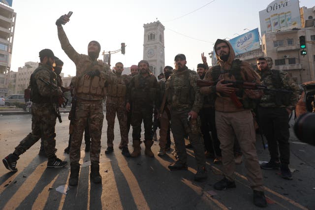 <p>Syrian anti-government fighters pose for a picture as they celebrate the capture of the city of Hama </p>