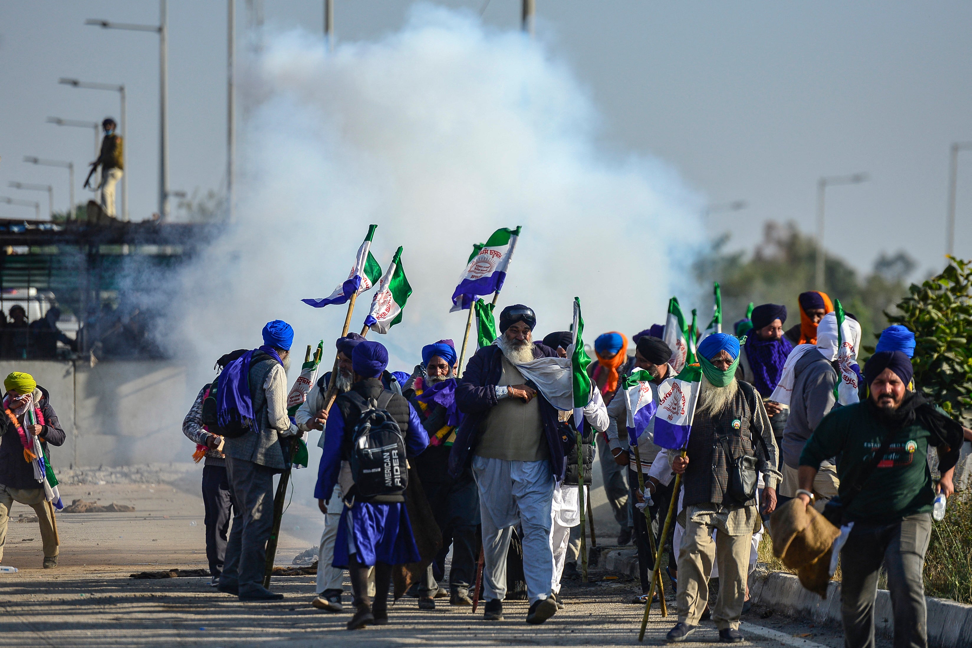 Farmers disperse after police fired tear gas to prevent them from marching towards India’s capital, Delhi, at the Shambhu Border in Punjab on 6 December 2024