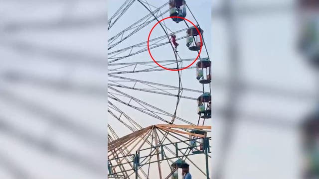 <p>Terrifying moment 13-year-old left dangling 60 feet above ground on ferris wheel</p>