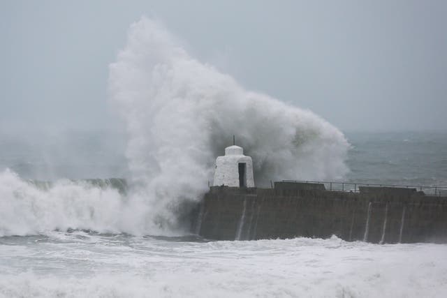 Waves pound against the harbour wall at Portreath, Cornwall (Cameron Smith/PA)