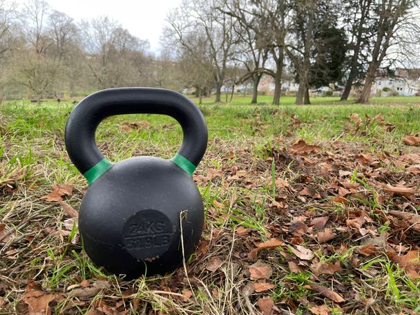 A 24kg kettlebell on the ground in a park