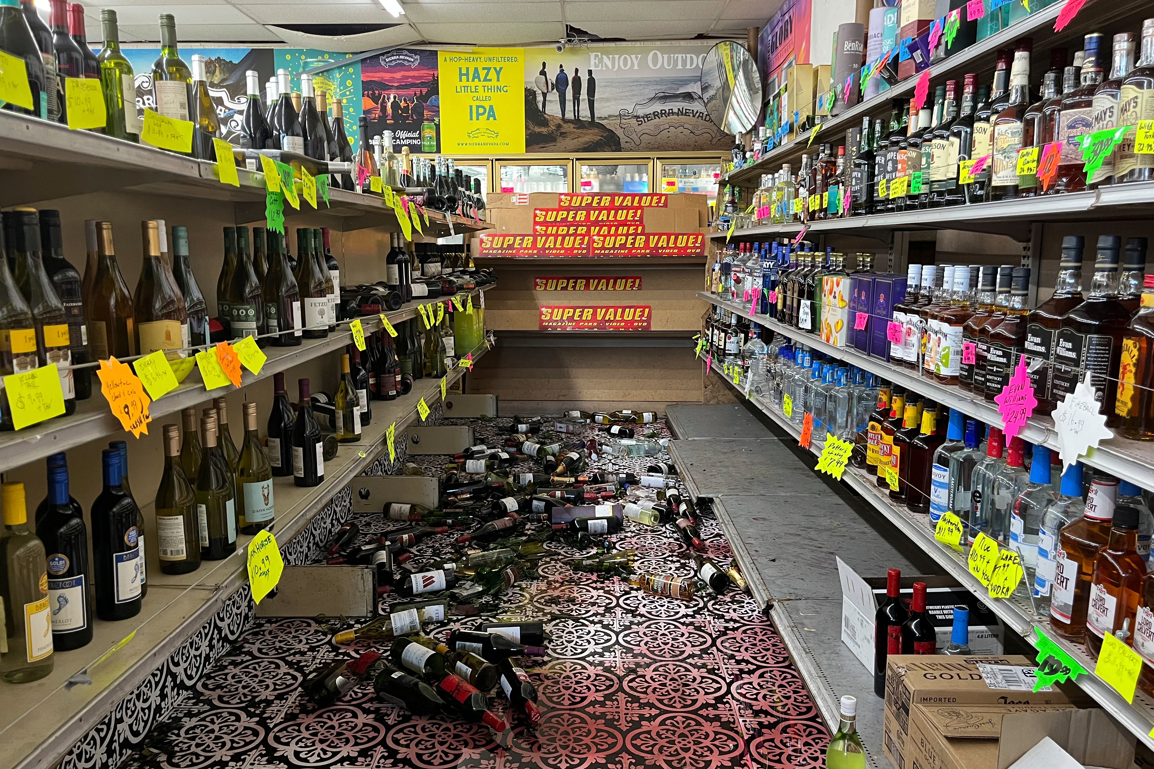 Broken bottles are scattered on the floor inside E&J Liquors after a 7.0 magnitude earthquake struck Thursday. Only minor damage was reported