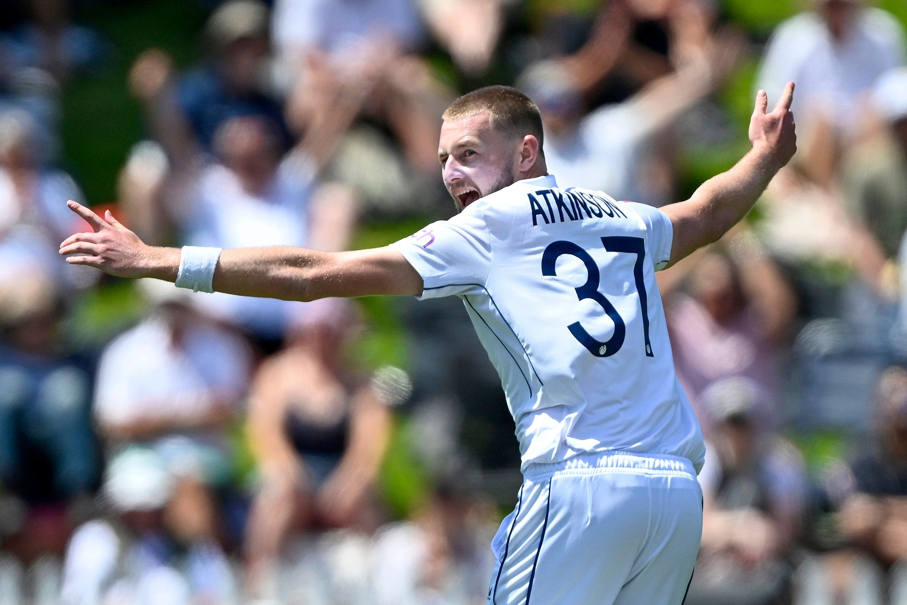 England bowler Gus Atkinson celebrates after taking a hat-trick (Andrew Cornaga/AP)