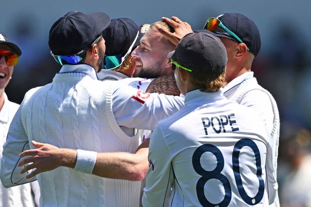 England Gus Atkinson, centre, celebrates with teammates after taking a hat trick (Kerry Marshall/Photosport via AP)