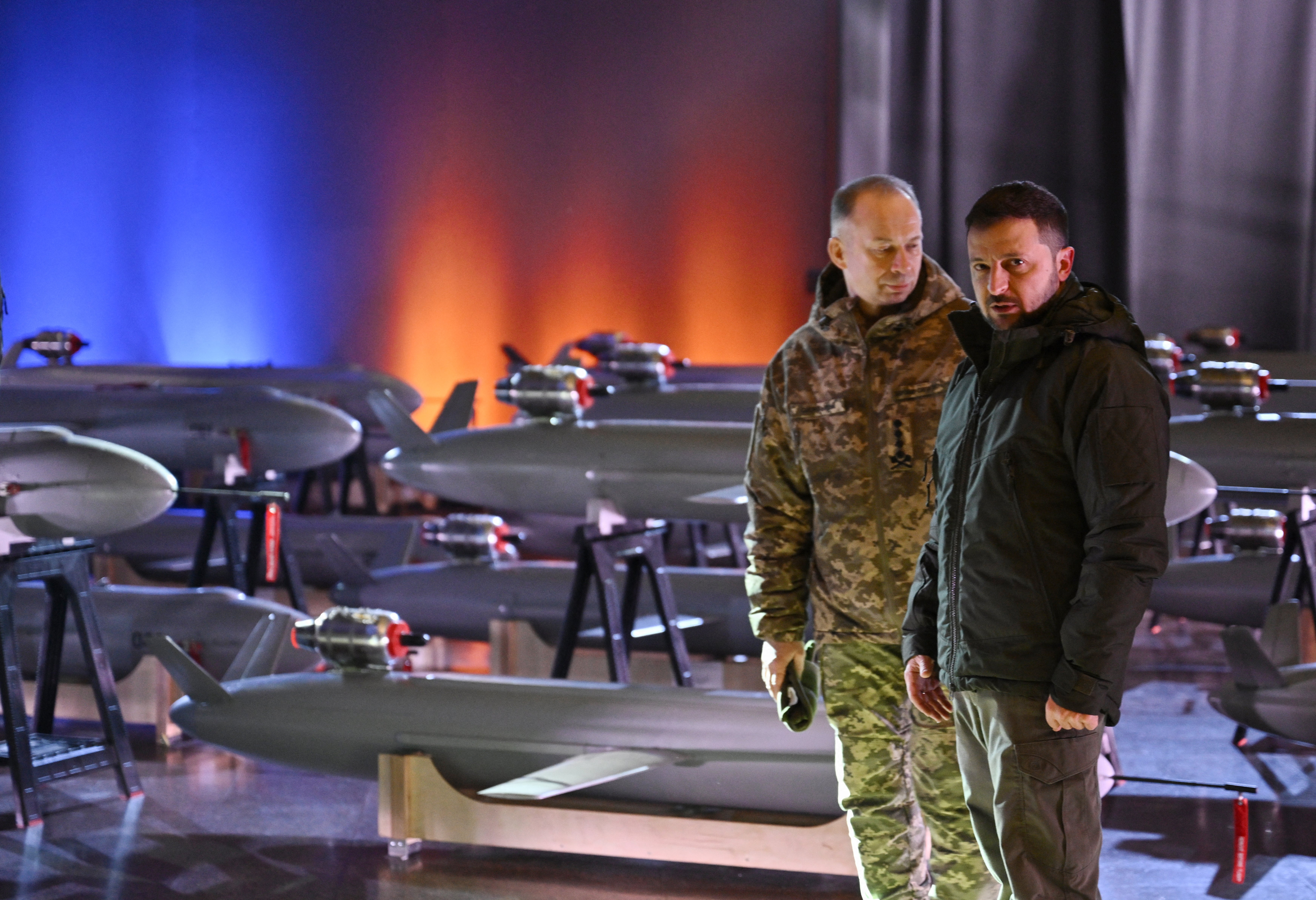 Ukrainian President Volodymyr Zelensky (right) and Commander-in-Chief of the Armed Forces of Ukraine Oleksandr Syrsky (left) speak next to the first batch of Ukrainian made drone missiles "Peklo" (Hell) delivered to the Defence Forces of Ukraine in Kyiv