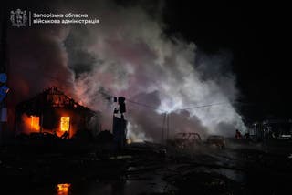 Firefighters extinguish a fire following a Russian attack in Zaporizhzhia