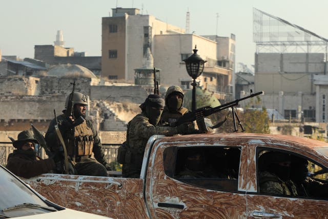 <p>Rebel fighters parade in the streets of Hama after capturing the city in central Syria </p>