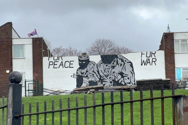 A wind-damaged loyalist paramilitary mural which previously read ‘prepared for peace, ready for war’, in the Mount Vernon area of north Belfast on Saturday morning (PA)