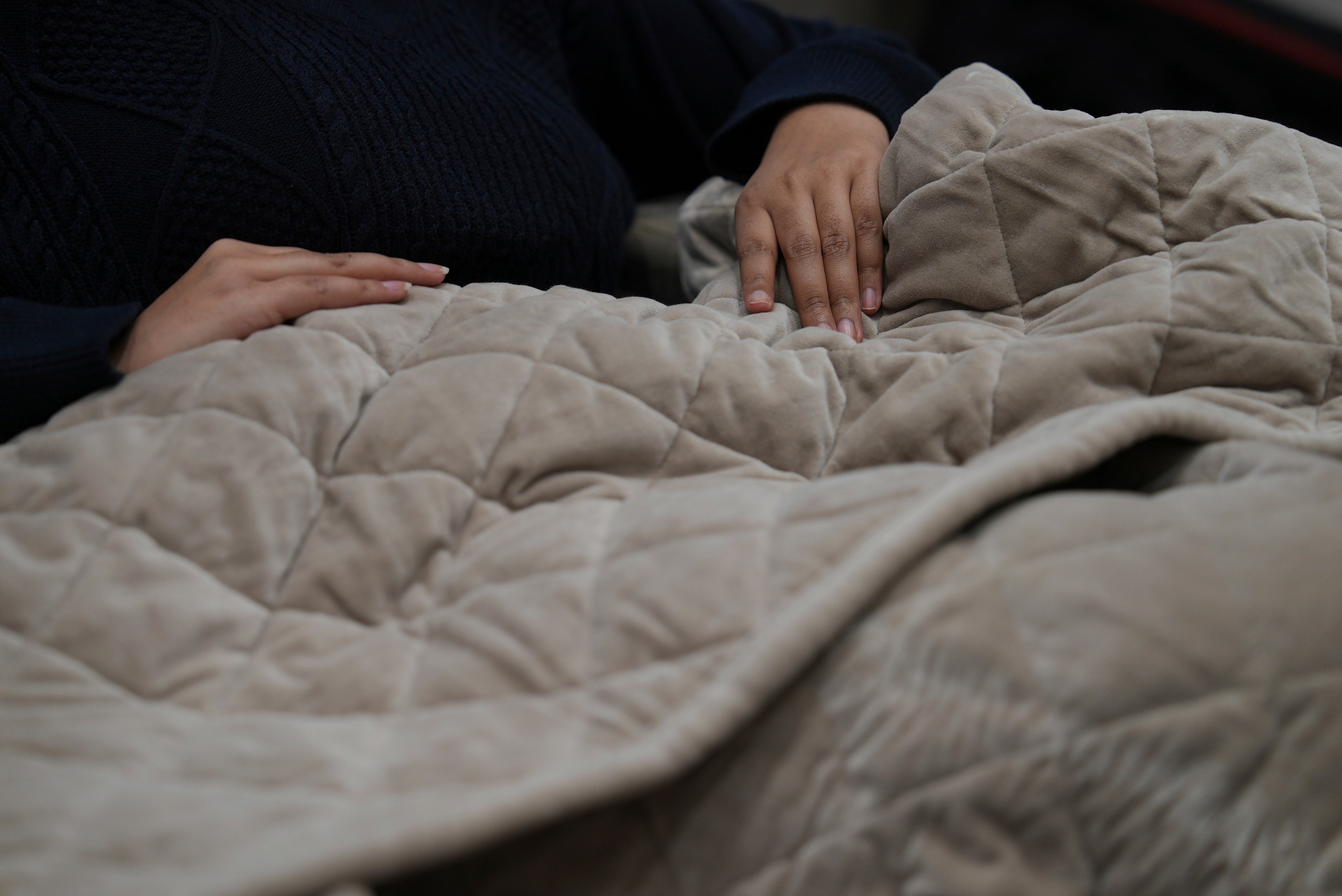 Weighted blankets on display in a Saatva mattress showroom in New York