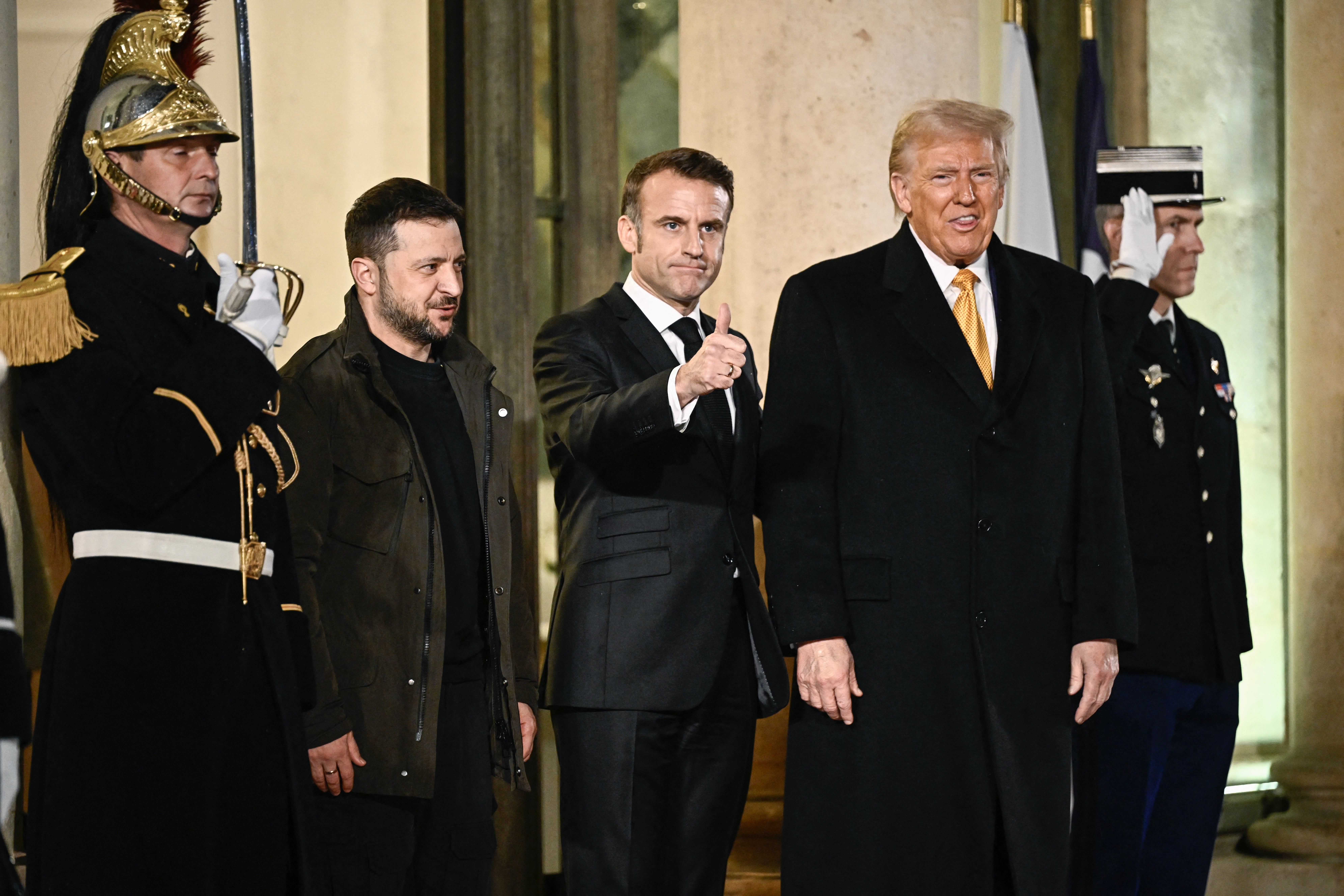 Ukrainian President Volodymyr Zelensky, French President Emmanuel Macron and President-elect Donald Trump stand outside the Elysee Presidential Palace in Paris on Saturday